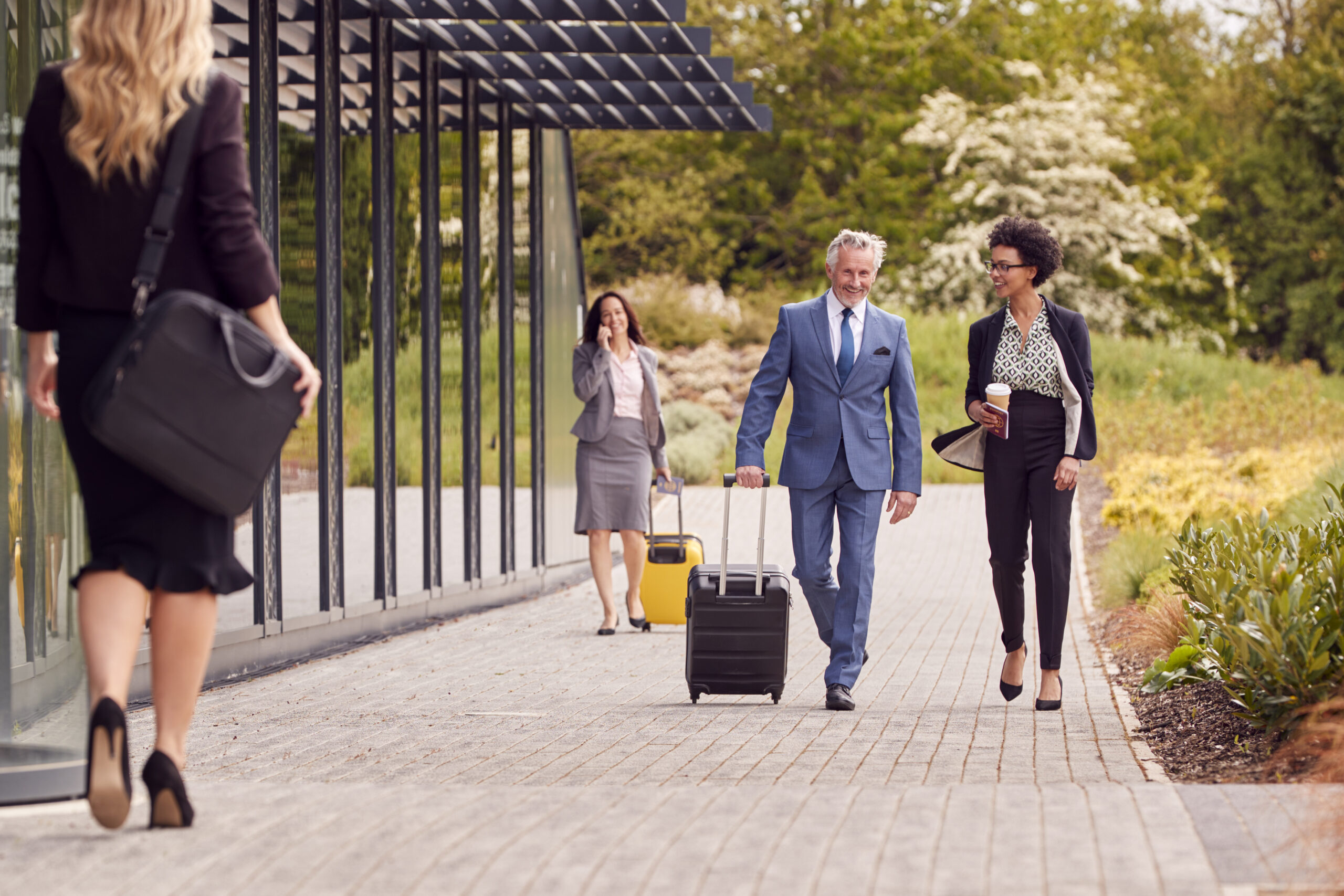 group of business delegates with luggage arriving 2024 10 19 20 45 08 utc scaled